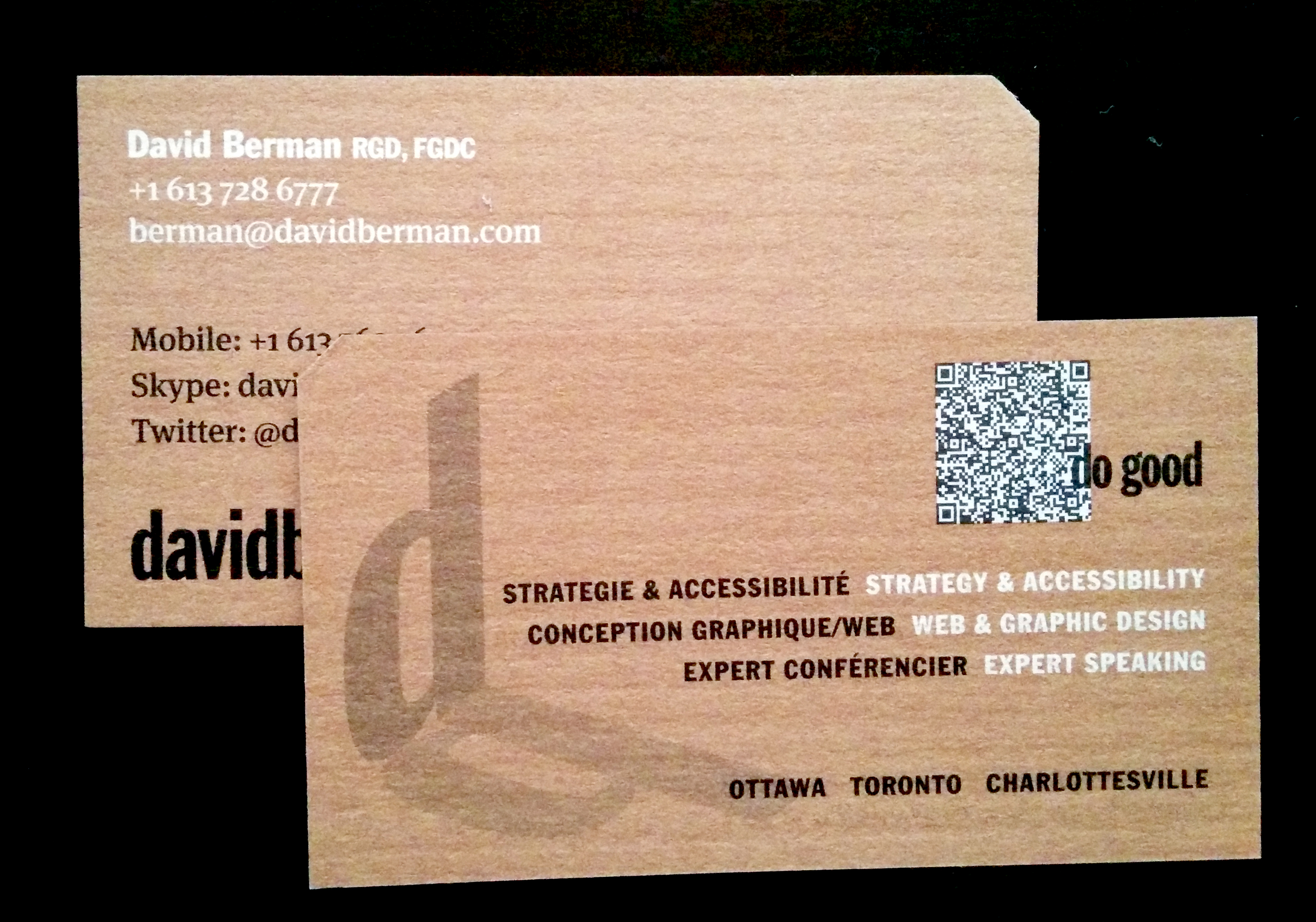 Photo of two David Berman Communications business cards front and back showing the Berman Corner