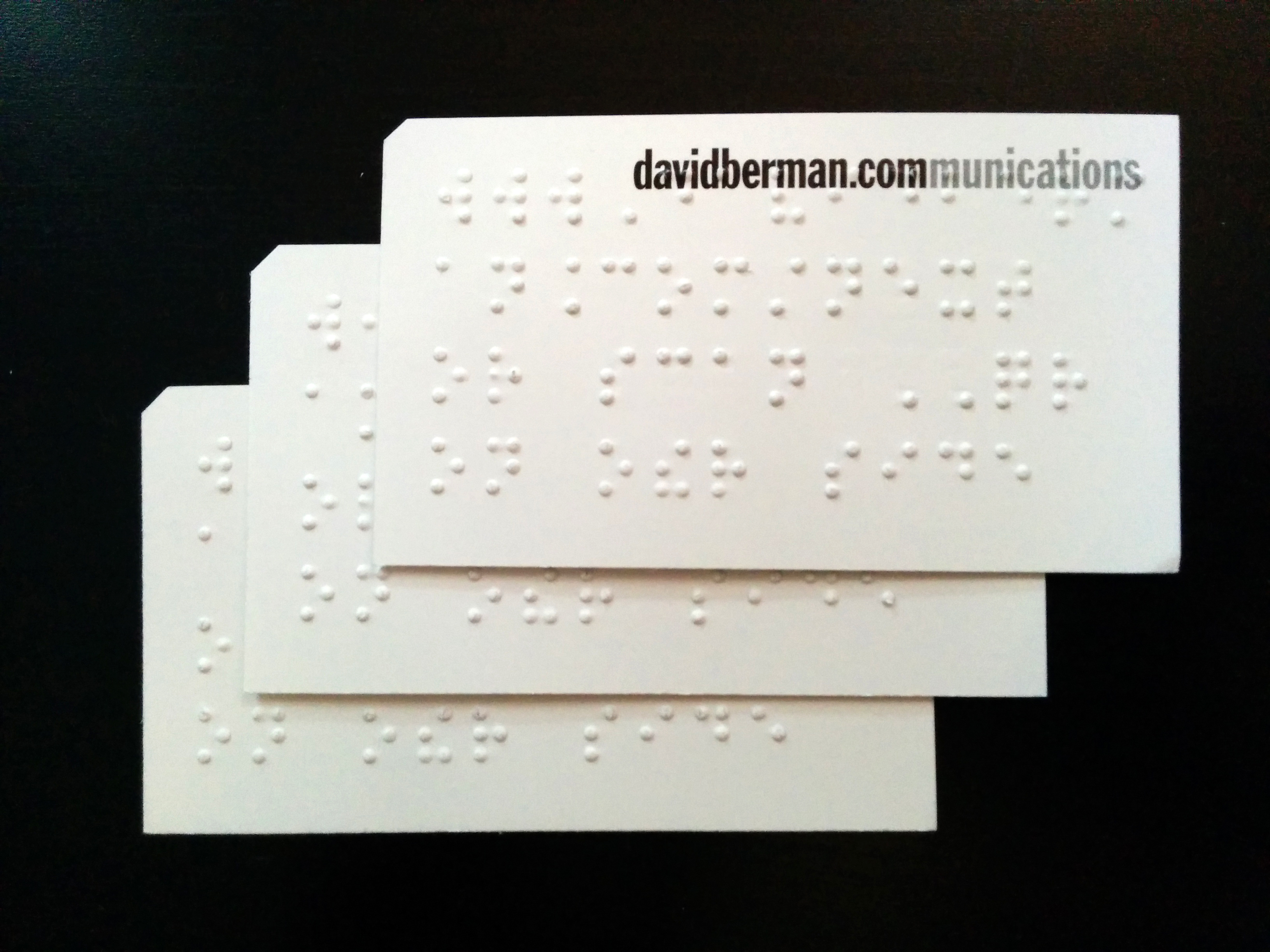 Photo of three David Berman Communications next event cards stacked on top of each other showing the Berman Corner