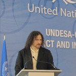 Photo of David Berman at the podium on a stage decorated with United Nations UNDESA and GAID branding