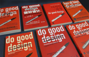 Seven copies of Do Good Design book by David Berman in various languages, laid out on black background