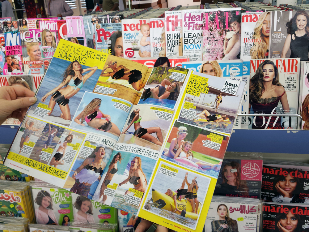 Image showing magazines with sharpie covering parts of women's bodies.
