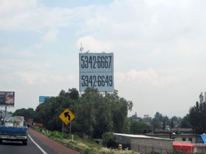 Photo of a billboard with the phone number of the owner.